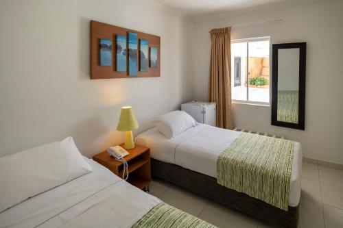 Una cama o camas en una habitación de Hotel El Dorado