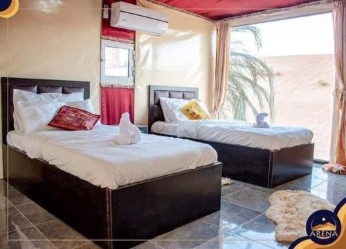 two beds in a room with two birds on them at Rum mona in Wadi Rum