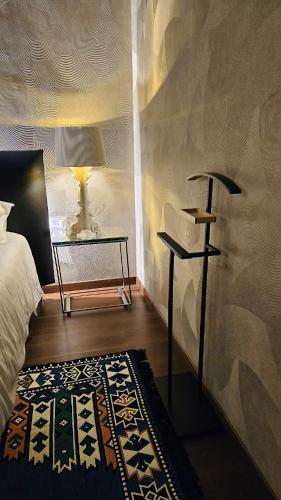 a bedroom with a bed and a table and a rug at Alba Suites in Vlorë