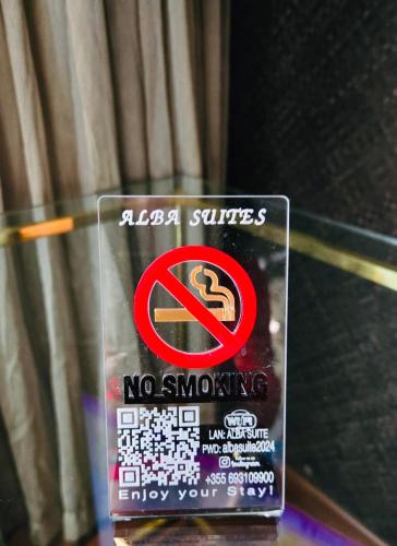 a sign that says no smoking on a glass table at Alba Suites in Vlorë