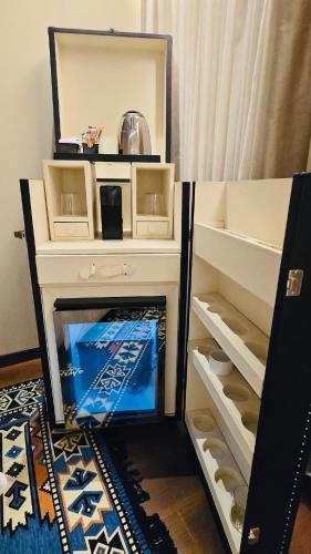 a mirror on top of a dresser in a bedroom at Alba Suites in Vlorë
