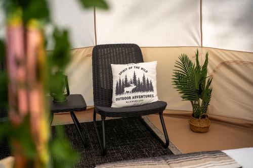 a pillow sitting on a chair in a tent at Grotto Getaway in Miller Lake