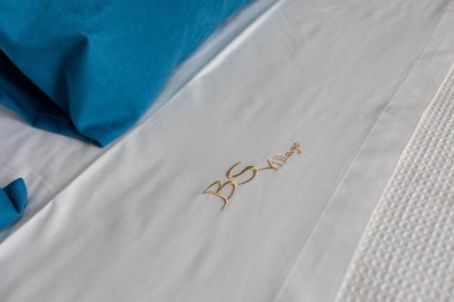 two pairs of scissors sitting on a white bed at BS Village in Metamorfosi