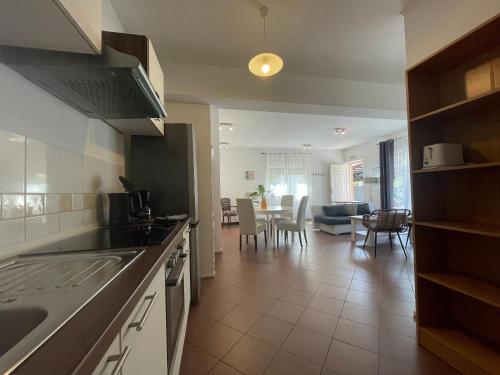 a kitchen and living room with a dining room at Blue Palm Apartment, Ika-Opatija in Ika