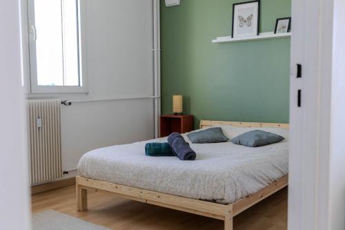 une chambre avec un lit avec deux oreillers dessus dans l'établissement Très bel appartement Mulhouse Parking gratuit, à Mulhouse