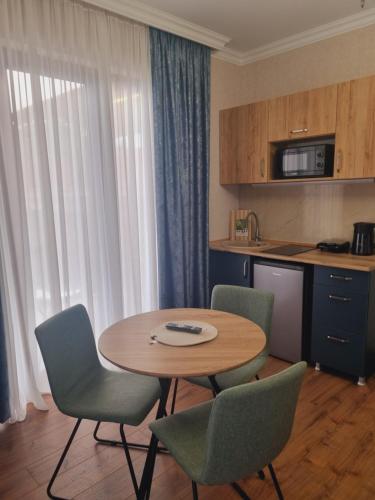 a kitchen with a table and chairs in a room at Lake House in Tskaltubo