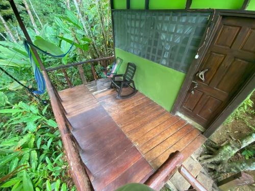 an overhead view of a wooden deck with a chair at GreenPoint Drake Bay in Drake