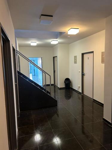 an empty room with a staircase in a building at Villa Blanca in Erpe-Mere