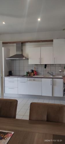 une cuisine avec des comptoirs et des placards blancs dans l'établissement Maison complete avec 5 chambres, à Montauban