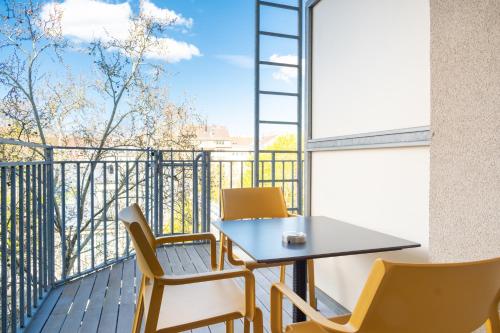 a table and chairs on a balcony with a view at Hotel Spiess & Spiess in Vienna