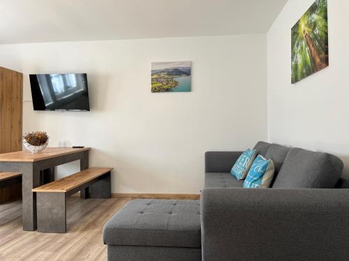 a living room with a couch and a table at Ferienwohnung Melissa in Unter Feuchten
