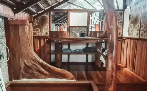 an inside view of a room with wooden walls and wooden floors at Hotel 3 Bamboo Ecolodge in Cahuita