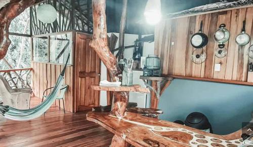 a living room with a hammock and wooden walls at Hotel 3 Bamboo Ecolodge in Cahuita