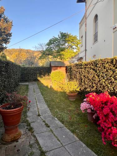 a garden with flowers in pots next to a building at Casa Bigallo - colline di Firenze in Bagno a Ripoli