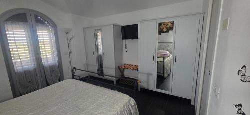 a bedroom with a bed and a mirror at Appartamento in villa Gra&Mary in San Giovanni in Marignano