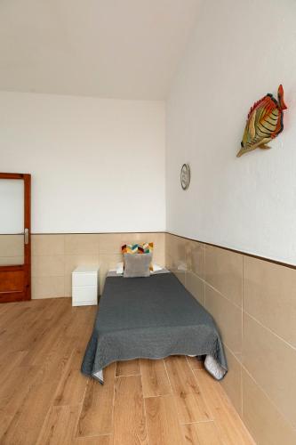 a bedroom with a bed and a fish on the wall at SALINETAS BLUE SURF HOUSE in Telde
