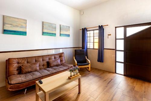 a living room with a couch and a table at SALINETAS BLUE SURF HOUSE in Telde