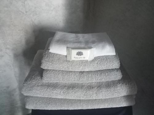 una pila de toallas sentadas en una mesa en Basaltic House Pedreira, en Lomba da Pedreira
