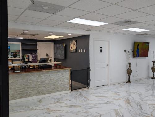 a large room with a counter and a kitchen at Heritage Inn Cartersville in Cartersville