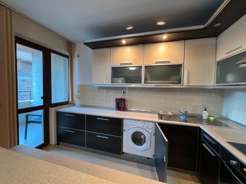 a kitchen with a washing machine in the middle at Victoria apartment - Sandanski in Sandanski