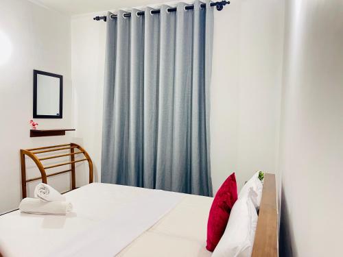 a bedroom with a bed and a window at Dreamy Heaven Negombo in Negombo