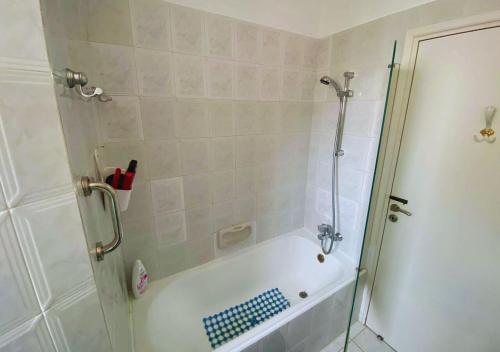 a bathroom with a shower and a bath tub at Villa Clementinka - 200 meters from the sea in Chlorakas