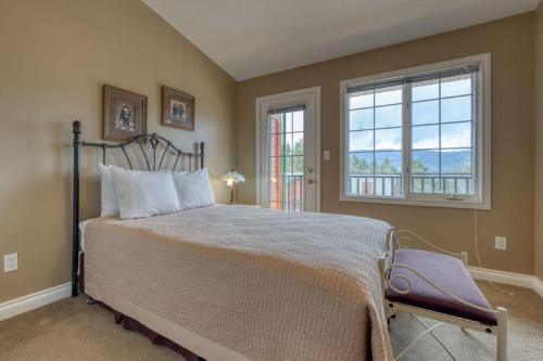 a bedroom with a large bed and a window at Marble Canyon in Fairmont Hot Springs