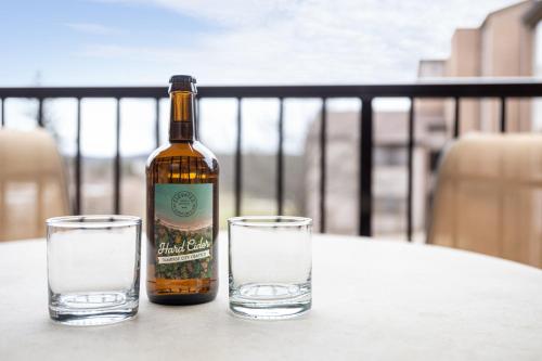 a bottle of wine and two glasses on a table at Valleyview Swing & Stay in Traverse City