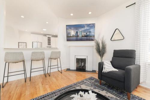 a living room with a couch and chairs and a fireplace at Stunning 2 Bedroom Apt in Historic Springfield in Jacksonville