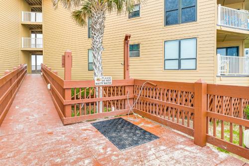 a house with a wooden deck with a sign on it at Steps to the Beach Oceanfront Condo with Lanai! in North Topsail Beach
