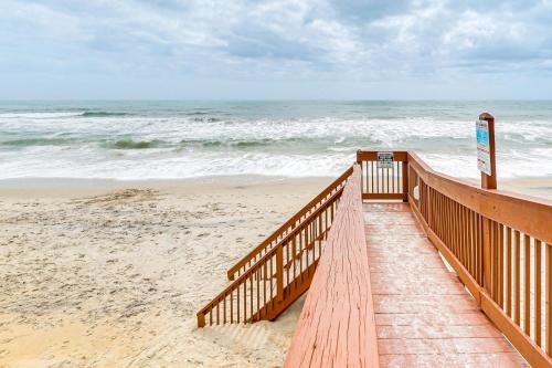 a wooden walkway to the beach with the ocean at Steps to the Beach Oceanfront Condo with Lanai! in North Topsail Beach