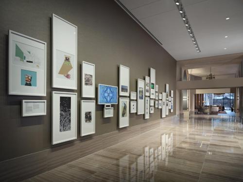 a hallway with a bunch of pictures on a wall at Omni Louisville Hotel in Louisville