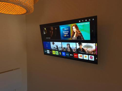 a flat screen tv hanging on a wall at City Centre Sanctuary with parking space in Worcester