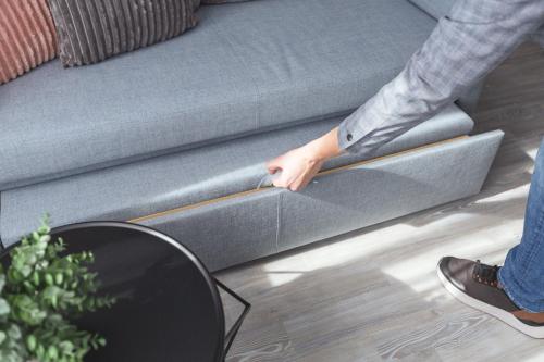 a person sitting on a couch with their hand on the armrest at Garner Hotel Essen - Messe by IHG in Essen
