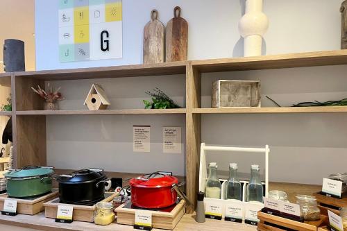 a shelf with pots and pans and other items on it at Garner Hotel Essen - Messe by IHG in Essen
