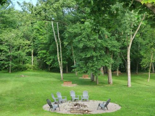 a group of chairs sitting on a circle in a park at Cozy Retreat Amidst Serene Nature- A Perfect Getaway in Porter