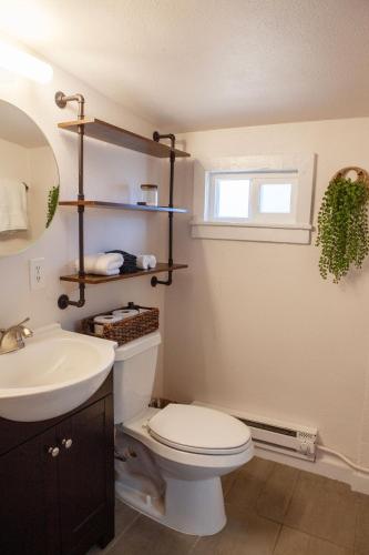 a bathroom with a white toilet and a sink at Zuni St Motor Inn- Bike, Dine, Explore Denver in Denver