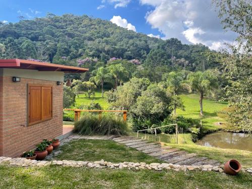 a house with a mountain in the background at Chez Ze in Gonçalves
