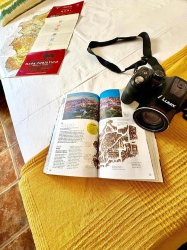 a book and a camera sitting on a table at Dos Olivas in Cobisa