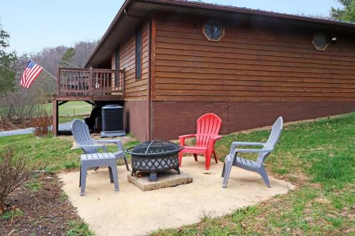 four chairs and a fire pit in front of a cabin at Mountain Cabin w Hot Tub Deck Grill & Fire Pit in Stanley