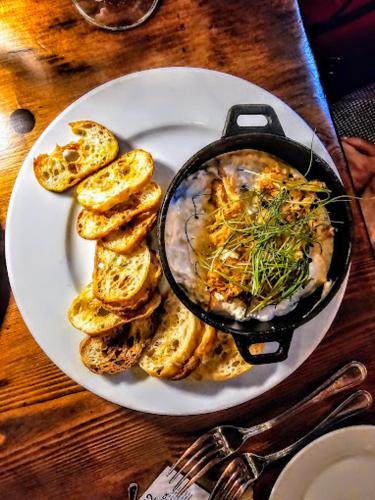 a plate of food with bread and a pot of food at Butter milk falls inn in Milton