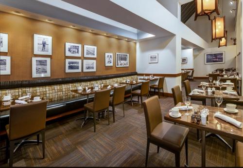 a restaurant with tables and chairs and a bar at Crowne Plaza Seattle Newly Renovated with No Resort Fee in Seattle