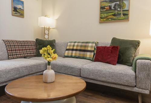 a living room with a couch and a table at Castlestone Holiday Cottages & Townhouses in Naas