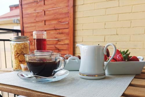a table with a cup of coffee and a mug at Casa Carrella in Salerno