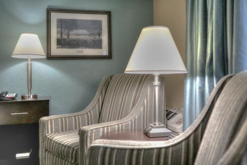 a hotel room with two chairs and a lamp on a table at Greystone Lodge on the River in Gatlinburg