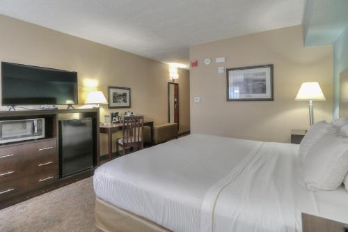 a hotel room with a large bed and a kitchen at Greystone Lodge on the River in Gatlinburg