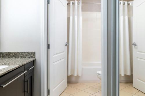 a bathroom with a toilet and a shower at Residence Inn by Marriott Fredericksburg in Fredericksburg
