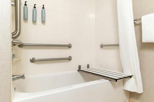 a bathroom with a bath tub and a toilet at Residence Inn by Marriott Fredericksburg in Fredericksburg
