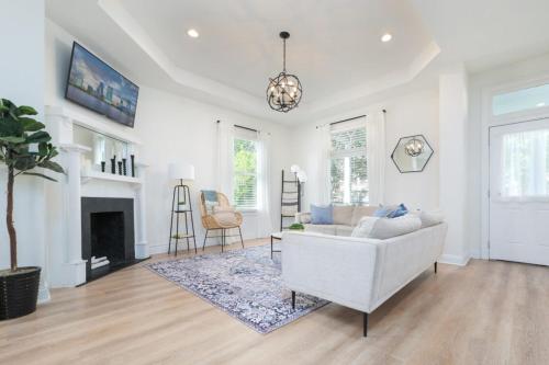 a living room with a couch and a fireplace at Elegant 2 BR apt in the heart of historic SPR - 5 min drive to TIAA Bank Field in Jacksonville