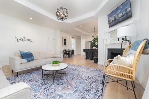 a living room with a couch and a table at Elegant 2 BR apt in the heart of historic SPR - 5 min drive to TIAA Bank Field in Jacksonville